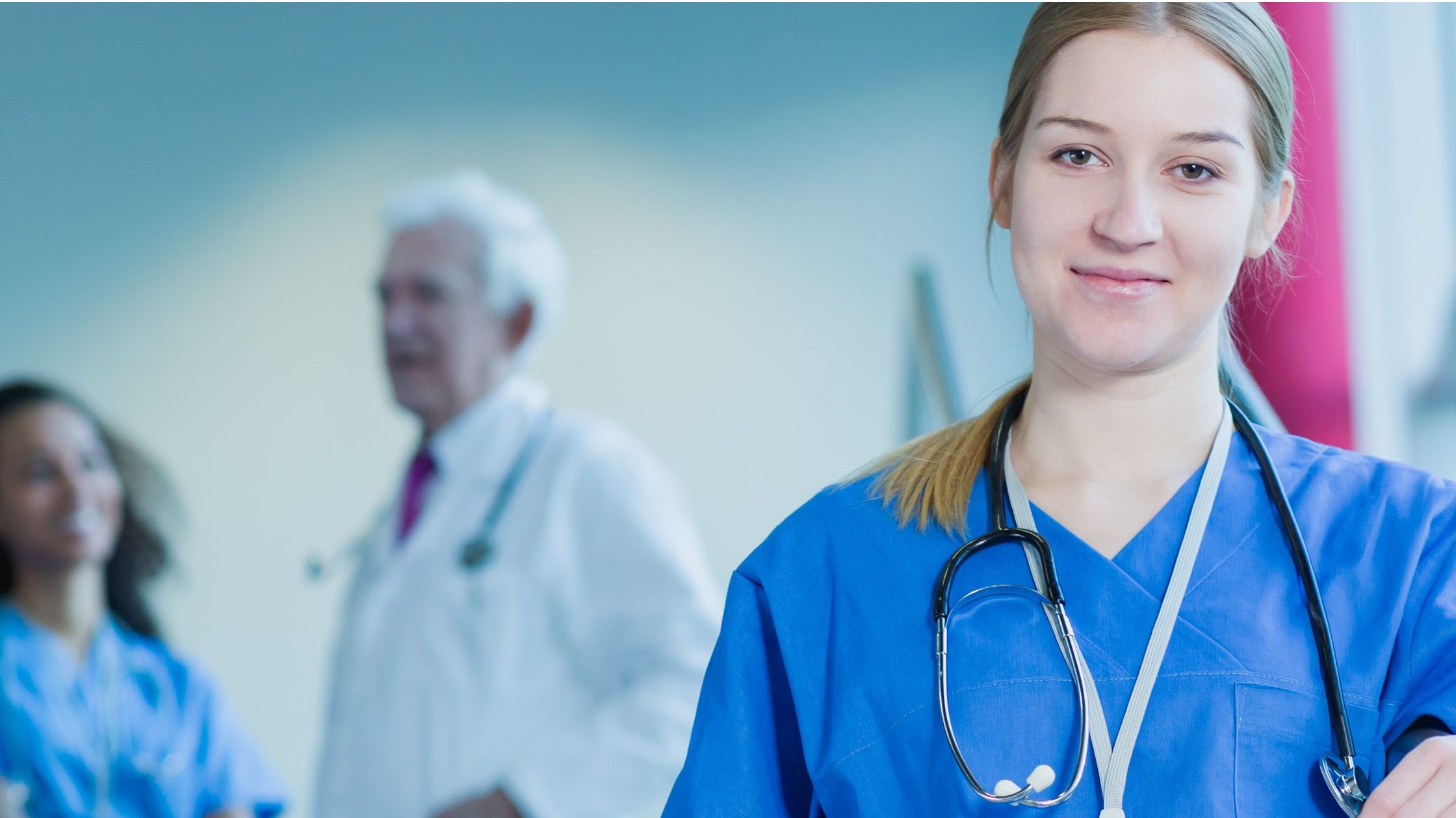 A resident that has matched into one of the most difficult specialties to match into standing in a hospital, wearing scrubs.